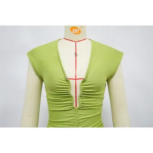 Detailed view of lime green deep V-neck ruched slim fit dress on mannequin stand