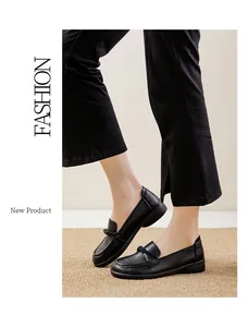 Macro view of black slip-on loafers for women with decorative knot detail and soft sole