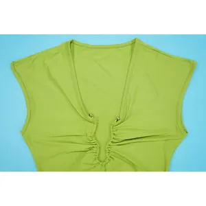 Detail of lime green deep V-neck dress with ruched front and bead accents.