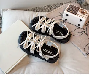 Detail view of girls' bow sandals with thick soles on a cozy lifestyle background