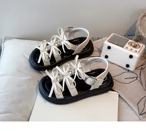 Girls' chic white bow sandals with thick black platform soles and decorative rhinestones