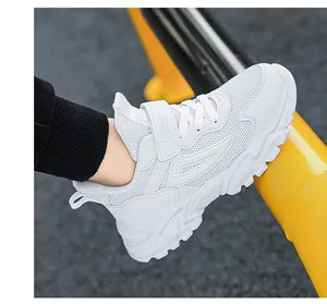 Side detail view of white breathable mesh children's sneakers with velcro strap design