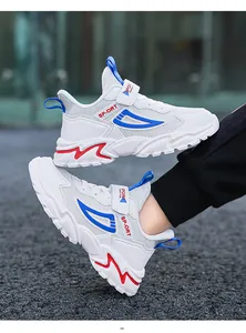 Detailed view of white breathable kids sneakers with blue and red sports accents