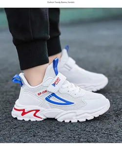 Breathable white children's sneakers with velcro strap and sporty accents
