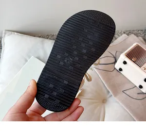 Detailed view of the non-slip black sole of girls' summer sandals with size 26 marking.