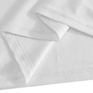 Macro detail view of the white breathable mesh fabric and durable hem stitching on polo shirt