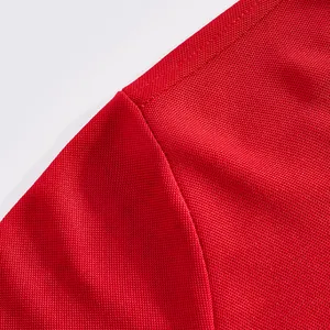 Close-up view of high-quality red mesh breathable fabric and durable seam on a men's Polo shirt