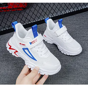 Detailed view of breathable white kids sports sneakers with blue and red accents