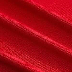 Detailed macro view of red mesh quick-dry fabric texture for men's performance polo shirt.