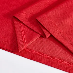 Close-up of red pique fabric and durable double-stitched hem of a men's polo shirt