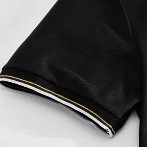 Close-up of black mesh polo shirt sleeve with white and yellow striped ribbed cuff