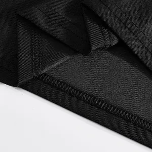 Close-up detail of black breathable mesh fabric and durable stitching for polo shirt.