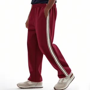 Detail shot of burgundy joggers with a contrasting white side stripe for a sporty look