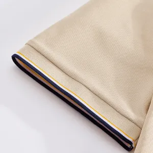 Close-up detail of a men's mesh polo shirt cuff featuring navy and yellow stripes.