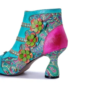 Close-up of bohemian leather ankle boots with 3D flower details and intricate embroidery