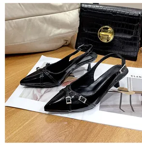 Eleganti décolleté slingback in vernice nera con fibbia su una rivista di moda