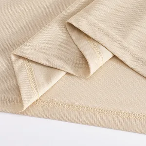 Close-up of quick-dry mesh fabric and hem stitching on a beige men's polo shirt.