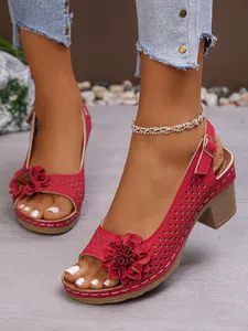 Side view detail of red chunky heel sandals featuring elegant decorative floral accents
