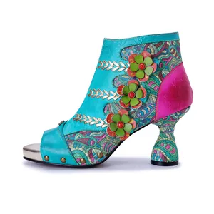 Side view of handmade genuine leather high-heeled boots with 3D flowers and paisley patterns.