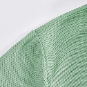 Macro detail showing the breathable green mesh fabric texture of this men's polo shirt