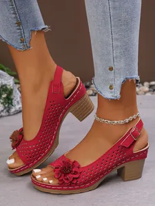Close-up of red chunky heel sandals with floral detail and hollow design for women