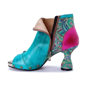 Detailed side view of colorful handmade leather patchwork high-heel booties with unique curved heel