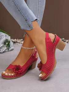 Red chunky heel sandals with laser-cut patterns and floral accent, fashion summer shoes.