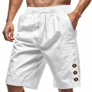 Detail view of white linen shorts with drawstring waist and brown buttons.