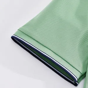 Detailed close-up of green mesh polo shirt sleeve featuring navy and white striped ribbing