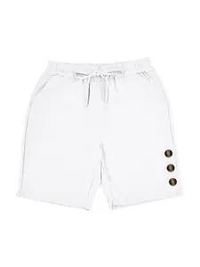 Detail of white men's linen shorts with decorative buttons and drawstring waist