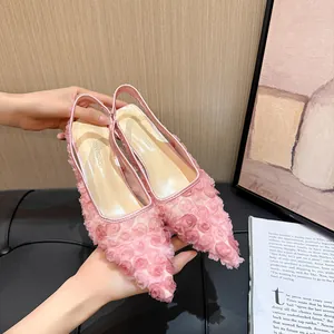 Detail of pink French lace mesh pointed-toe slingback heels with 3D floral textures