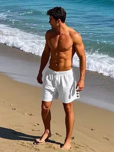Men's white linen beach shorts with elastic drawstring waist and side button detail.