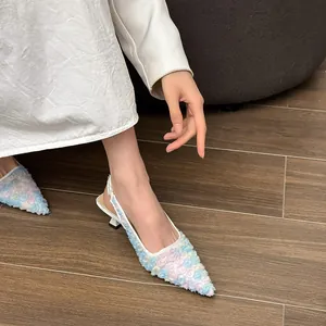 Close-up of 3D floral lace mesh texture on elegant pointed-toe slingback heels.