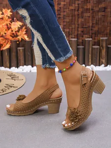 Tan chunky block heel sandals with floral detail and perforated strap design