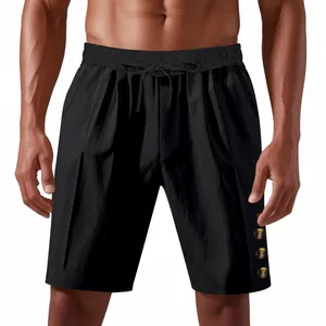 Detail of men's loose black linen shorts with drawstring waist and decorative button accents