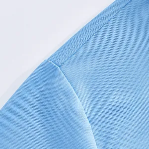 Macro detail of light blue breathable mesh fabric and seam on a men's polo shirt.