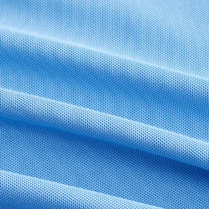 Close-up of breathable light blue pique mesh fabric for men's quick-dry polo shirt