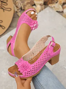 Close-up of pink flower chunky heel sandals with cutout design and adjustable buckle strap