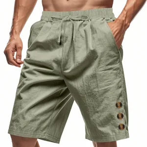 Detailed view of men's sage linen shorts featuring drawstring waist and decorative side buttons
