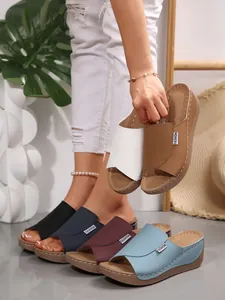 Detailed view of fashionable wedge sandals with peep-toe and wide straps in various colors.