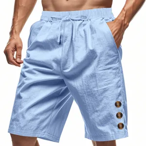 Detail view of light blue linen shorts for men with decorative buttons on the leg