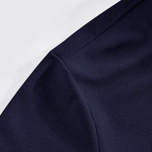 Macro view of navy blue breathable mesh fabric and seam detail on men's polo shirt