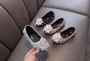 Close-up of sparkling rhinestone girls princess shoes in silver, gold, black and pink
