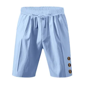 Detail view of light blue linen shorts featuring drawstring waist and decorative buttons.