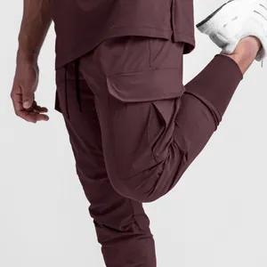 Détail d'un pantalon cargo de sport marron pour homme avec poche et bord-côte fin