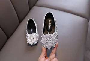 Detailed view of silver rhinestone princess shoes for girls with elegant pearl accents.