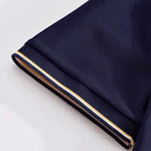 Close-up of navy blue mesh polo shirt sleeve with yellow and white striped ribbed cuff