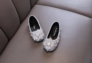 Detail of sparkling silver rhinestone girls' princess shoes with snowflake ornament