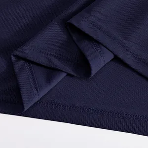 Macro detail of high-quality hem stitching on navy blue quick-dry mesh Polo shirt.