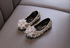 Detailed view of children's princess flats featuring intricate rhinestones and pearls